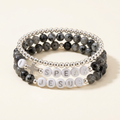 I Speak Jesus three-bracelet stack with silver bracelet on top, I Speak in the middle, and Jesus on the bottom