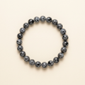 Handmade black larvikite bead bracelet on a warm ivory background