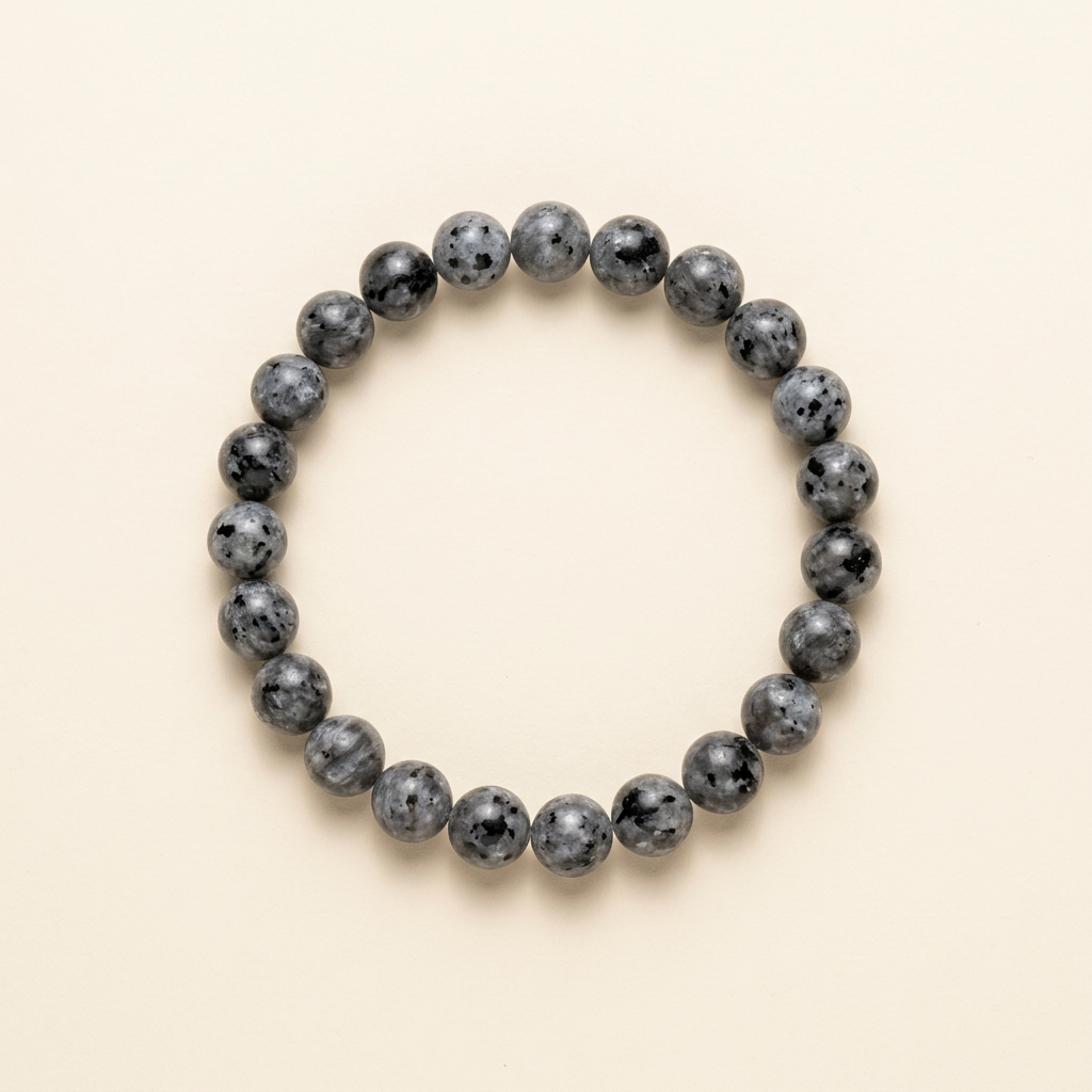 Handmade black larvikite bead bracelet on a warm ivory background