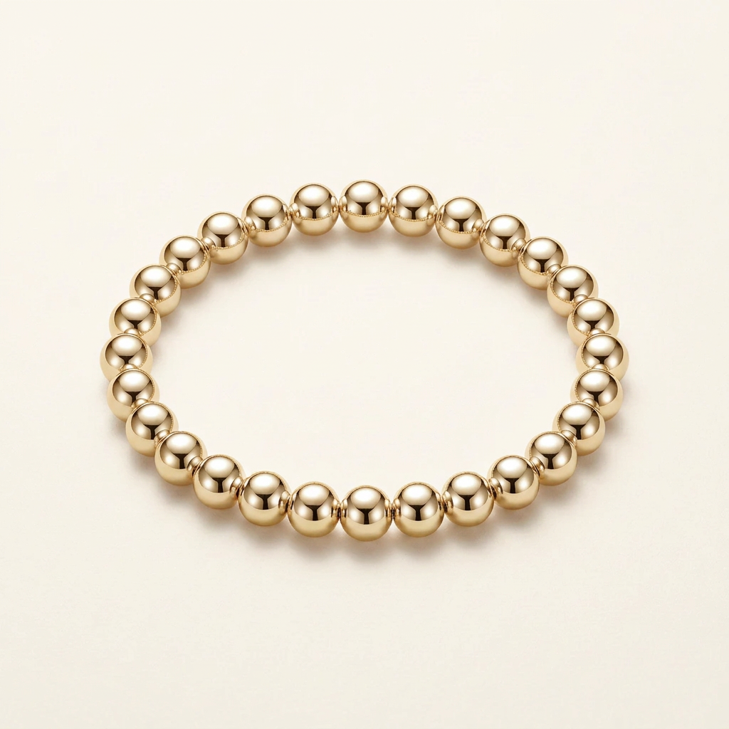 8 mm gold-plated bead bracelet on a warm ivory background