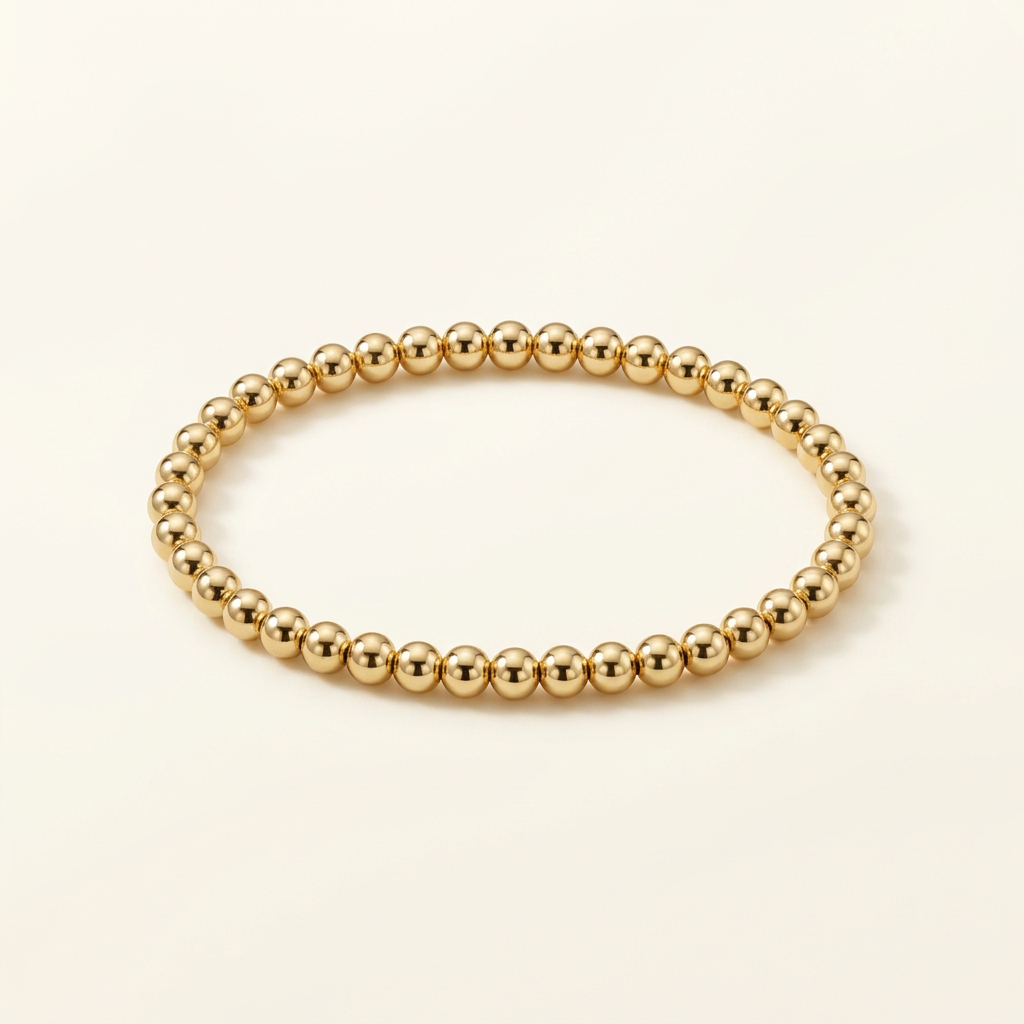 4 mm gold-plated bead bracelet on a warm ivory background