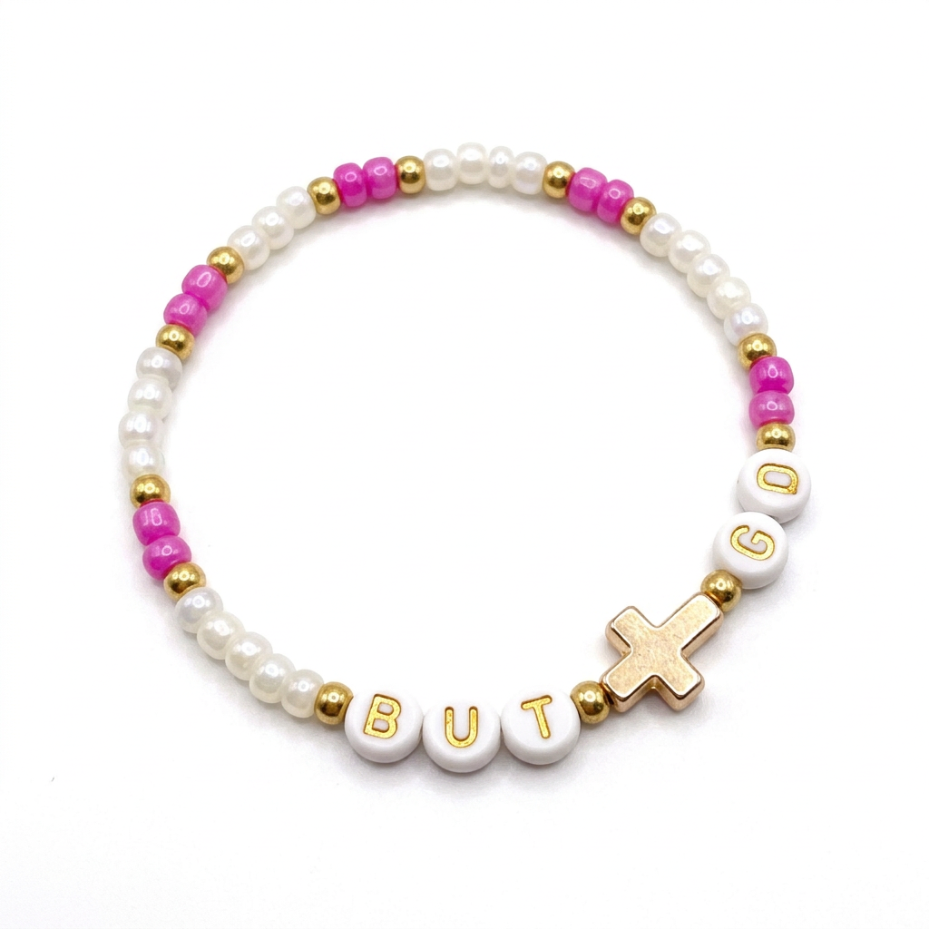 Pink and translucent white beaded bracelet with gold-tone accents and a cross detail on a white background.