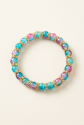 Multicolored glass bead bracelet with gold-colored spacers on an off-white background