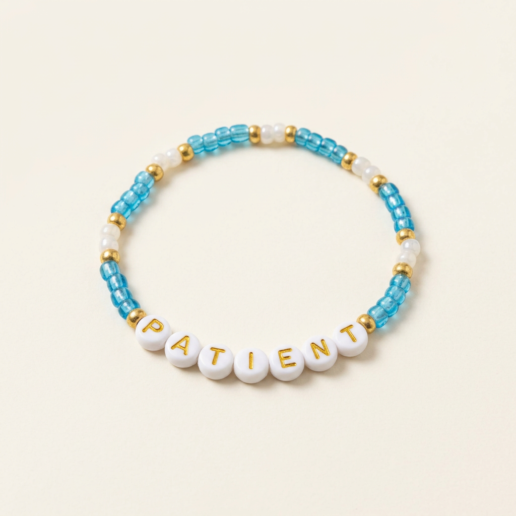 Patient bracelet with blue and white beads and gold-tone accents on an ivory background