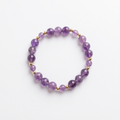 Purple amethyst bracelet with gold-plated spacers on a white background