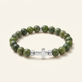 Canadian jade bracelet with silver-tone spacers and a silver-plated cross on a warm-white background