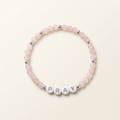 Pink rose quartz PRAY bracelet with silver-colored accents arranged in a circle on ivory