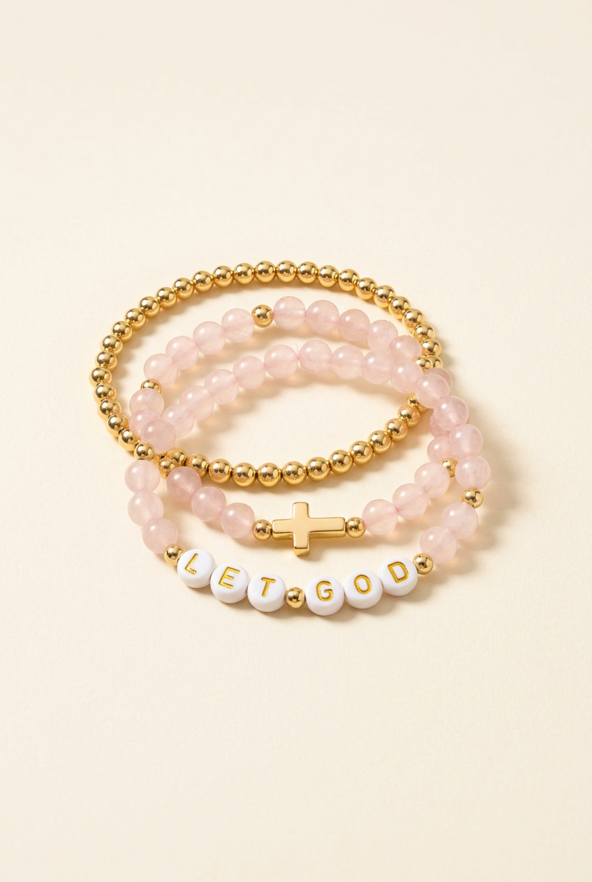 Pink quartz LET GOD three-bracelet set with gold-colored cross and gold-plated bracelet on ivory