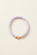 Pastel clay bead bracelet with a cross on a clean off-white background