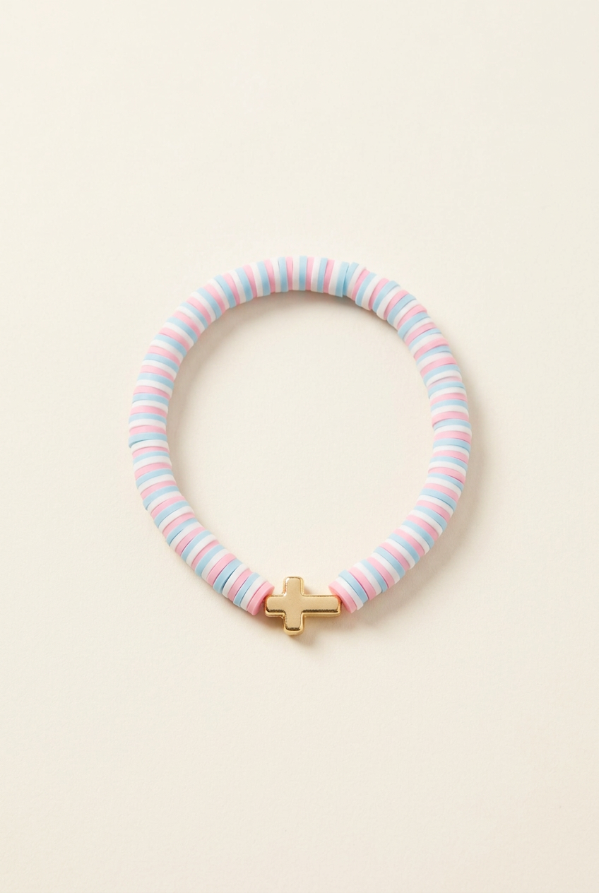 Pastel clay bead bracelet with a cross on a clean off-white background