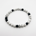 White howlite and black onyx beaded bracelet on a white background