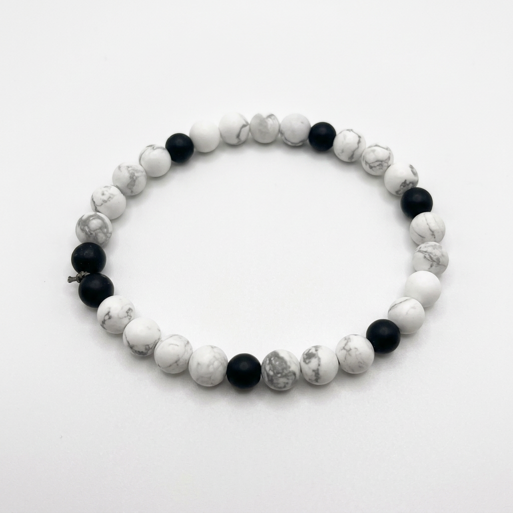 White howlite and black onyx beaded bracelet on a white background