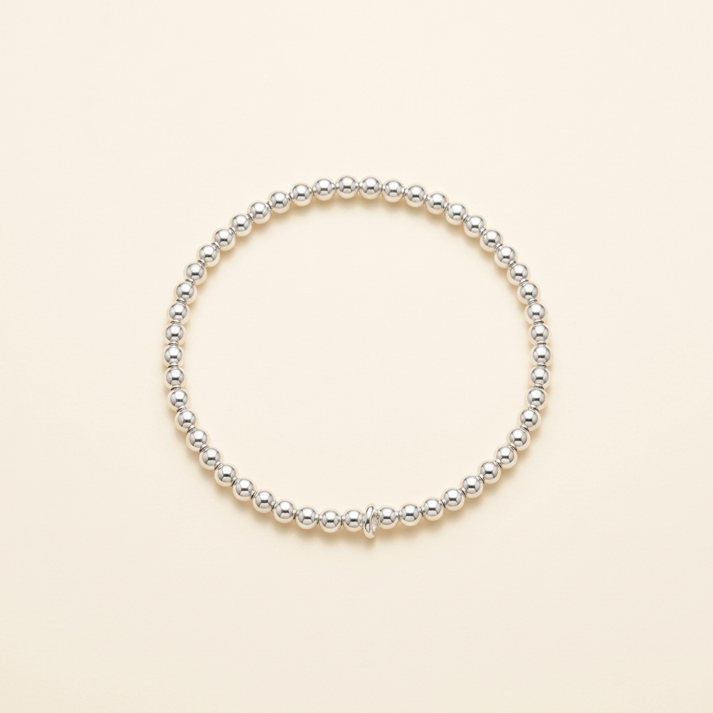 3 mm silver-plated bead bracelet on a warm ivory background