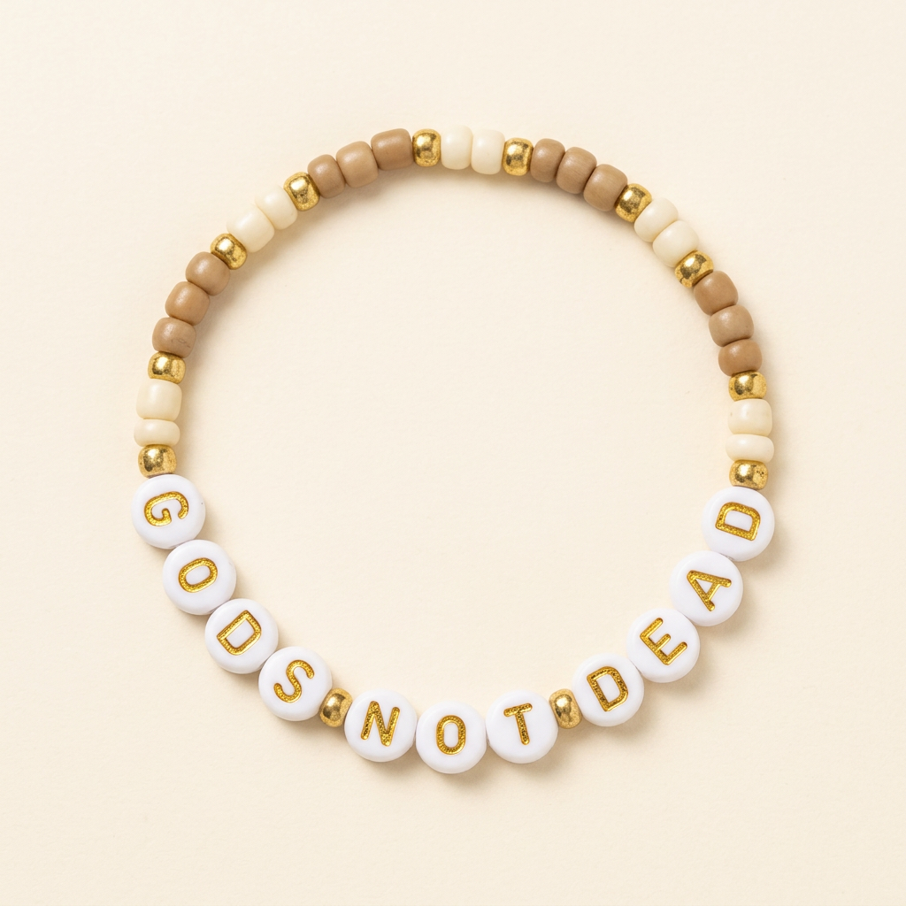 Tan and cream God’s Not Dead seed bead bracelet with gold-colored accents on an ivory background
