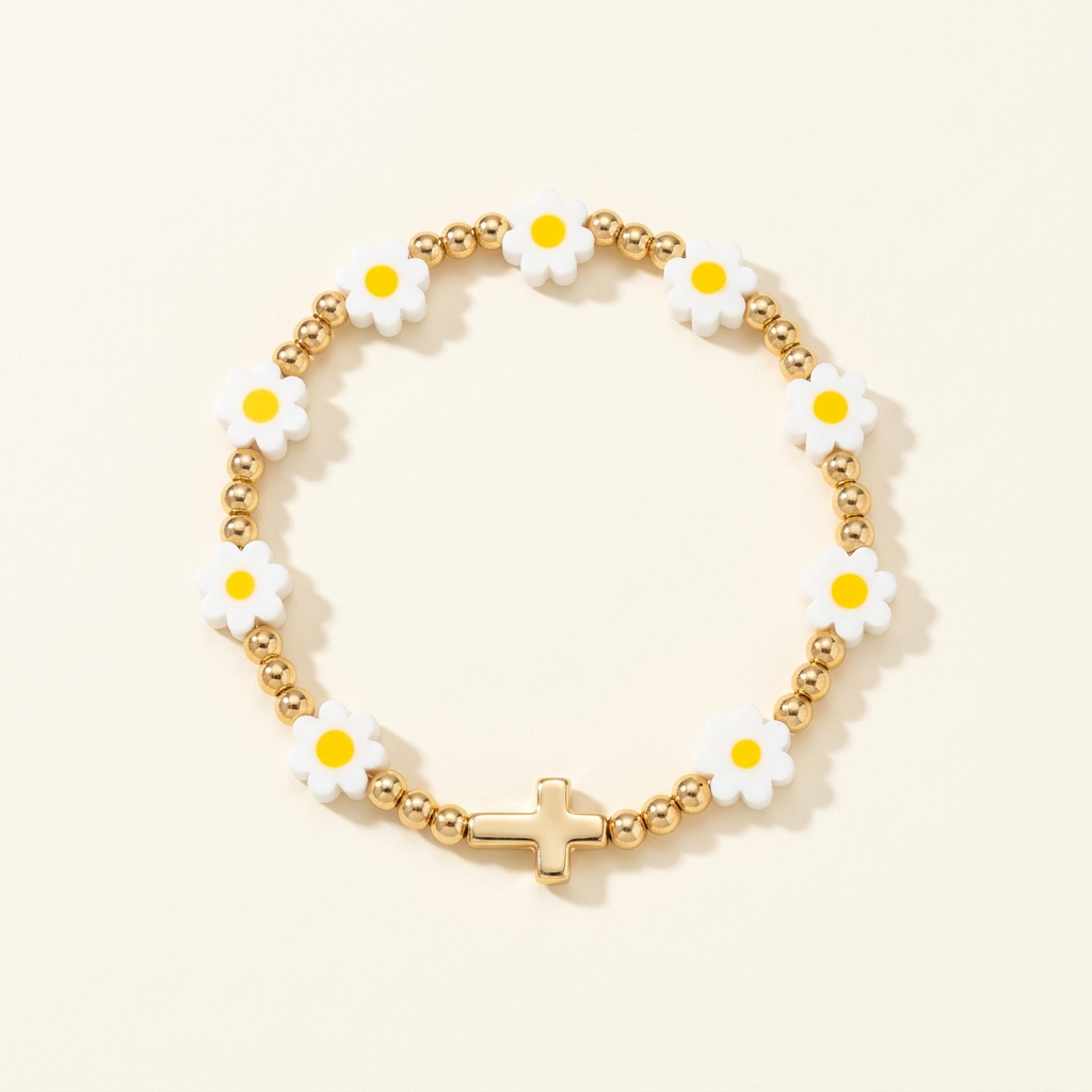 Handmade daisy bracelet with gold-plated beads and a gold-colored cross on a warm ivory background