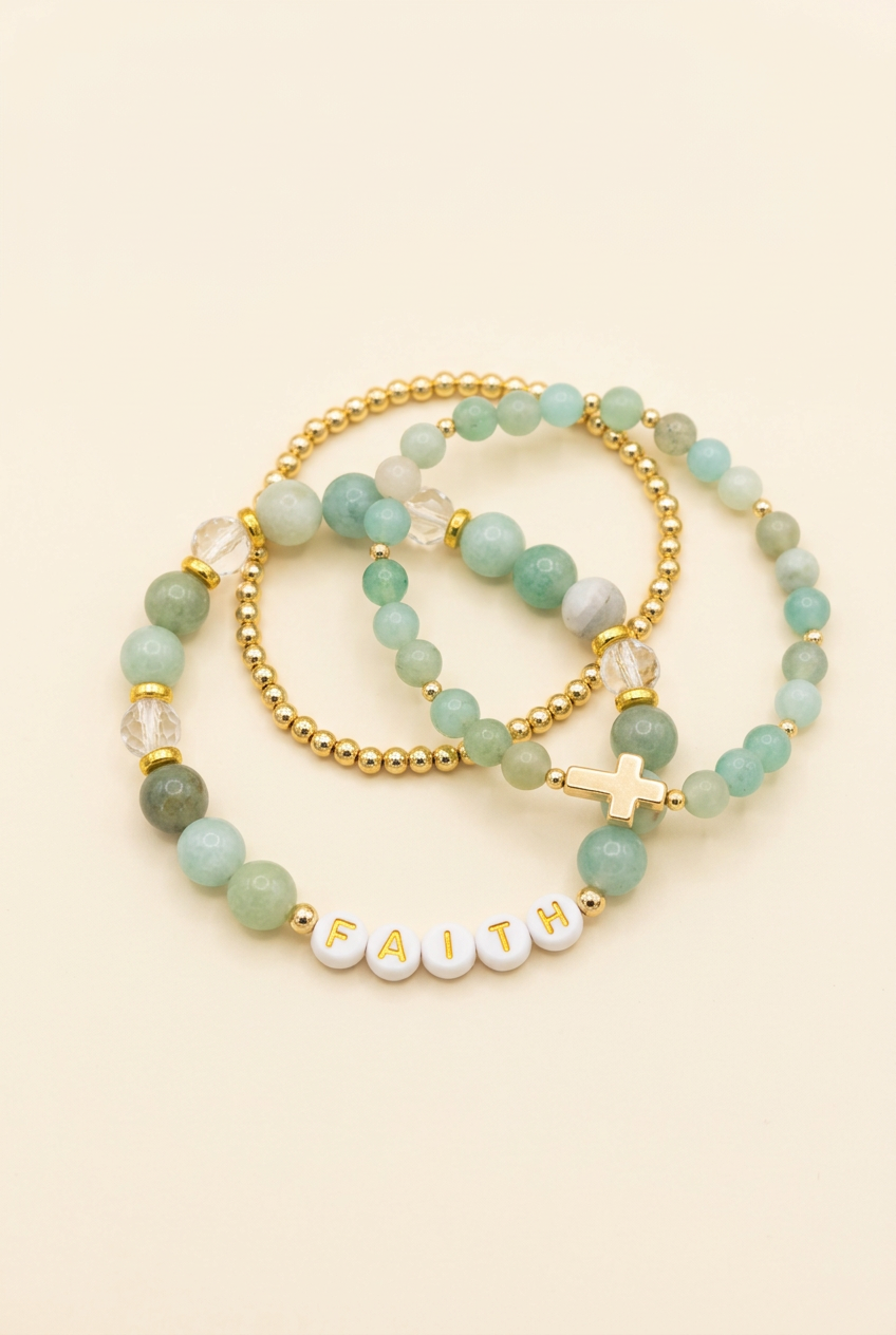 Cloudy jade FAITH bracelet set with quartz spacers, a gold-colored cross and a gold-plated bead bracelet on ivory