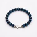 Aquamarine tiger eye beaded faith bracelet with a sideways silver cross on a white background