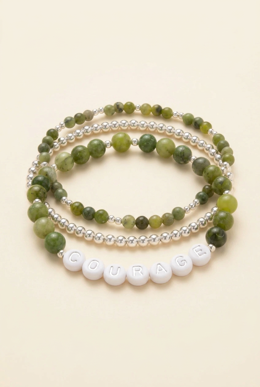 Courage Canadian Jade Affirmation Bracelet Set arranged in a stack on a warm ivory background