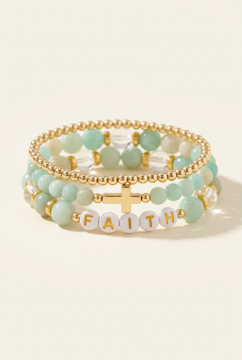 Handmade smooth amazonite faith three-bracelet stack with gold details on a warm ivory background