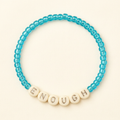 Enough handmade aqua-blue seed bead bracelet on an ivory background